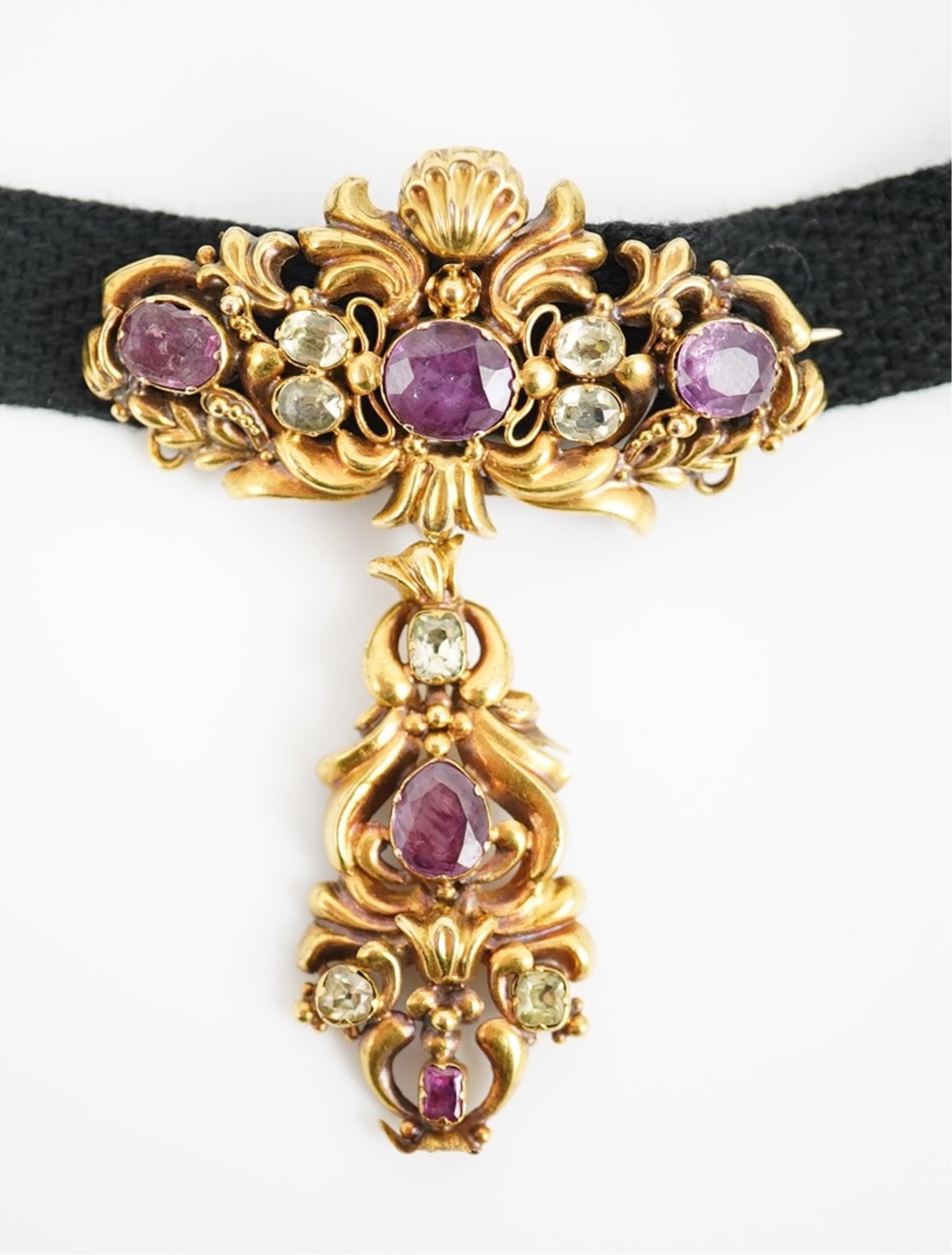 A Victorian yellow metal, garnet and chrysoberyl cluster set drop brooch, 56mm, on a black sash necklet